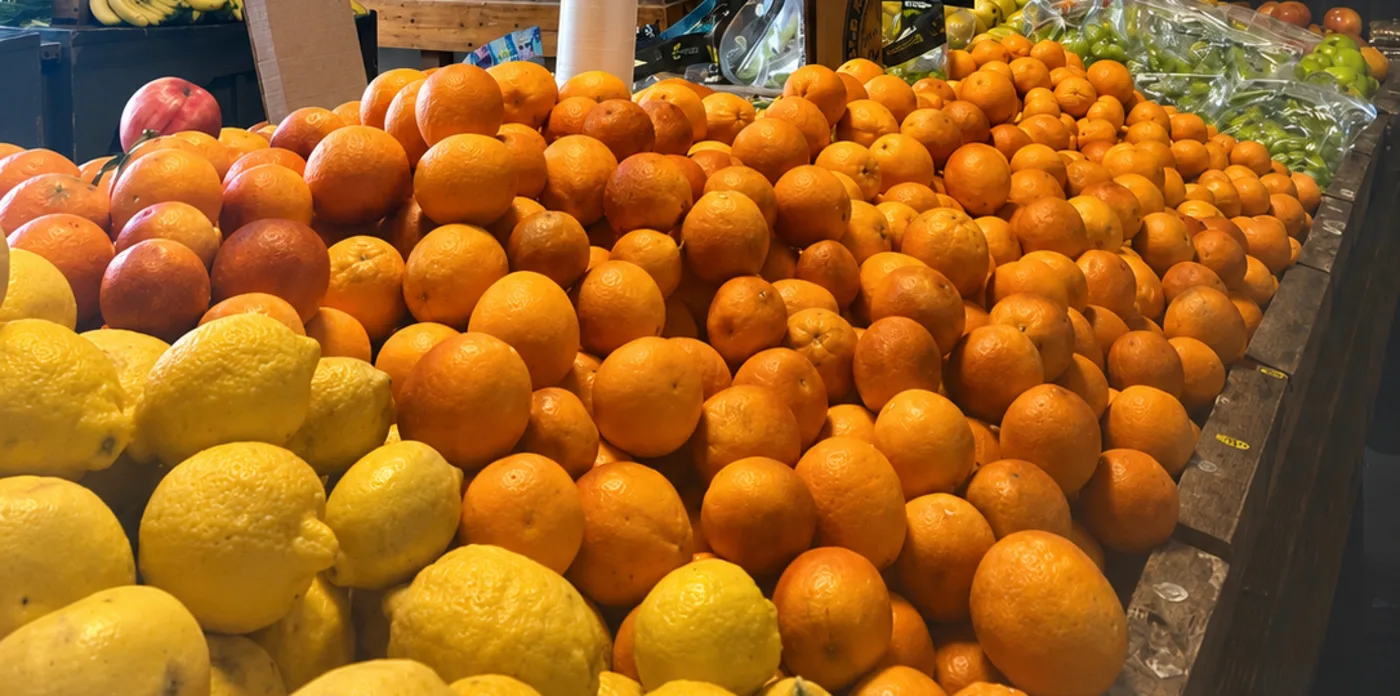 A table piled with fresh oranges, lemons and grapes at The Fruit Stand